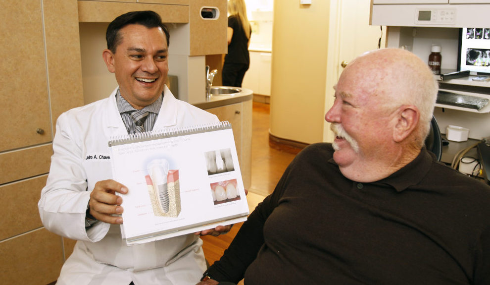 Dr. Chavez and a patient discuss treatment during a dental implant consultation.