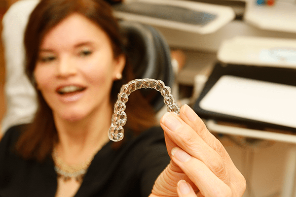 A patient holding Invisalign