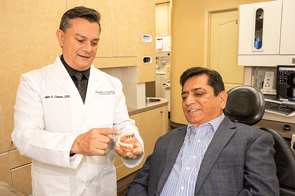 Dr. Chavez shows a patient regarding full-mouth reconstruction