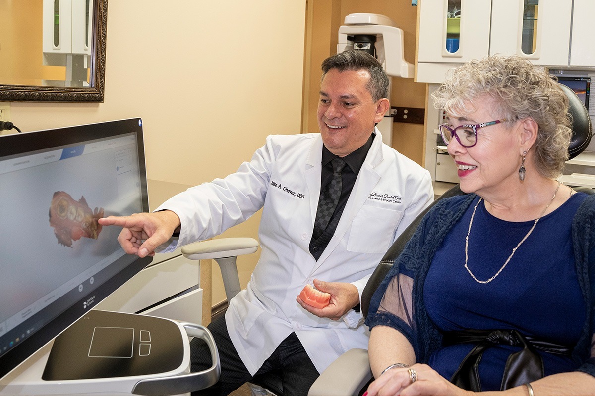 Dr. Chavez shows a patient a teeth model on a scanner